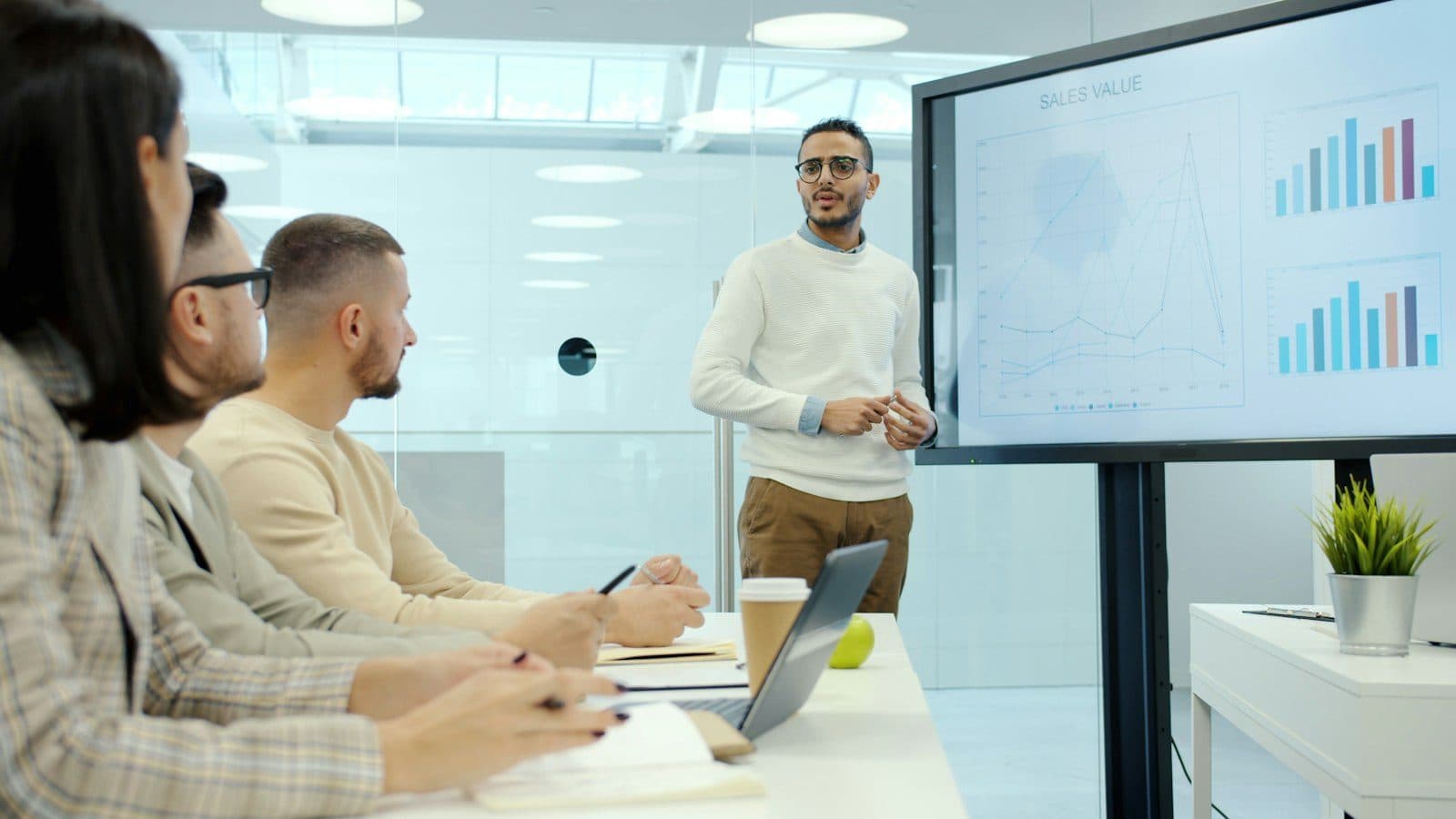 A scientist presenting charts to colleagues