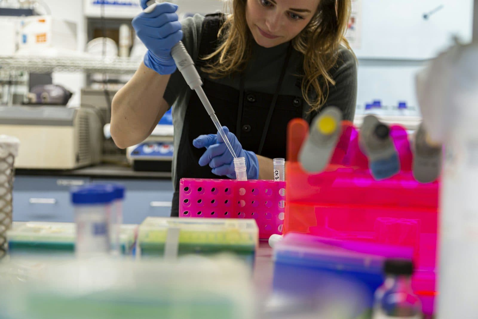 A researcher pipetting samples in a laboratory