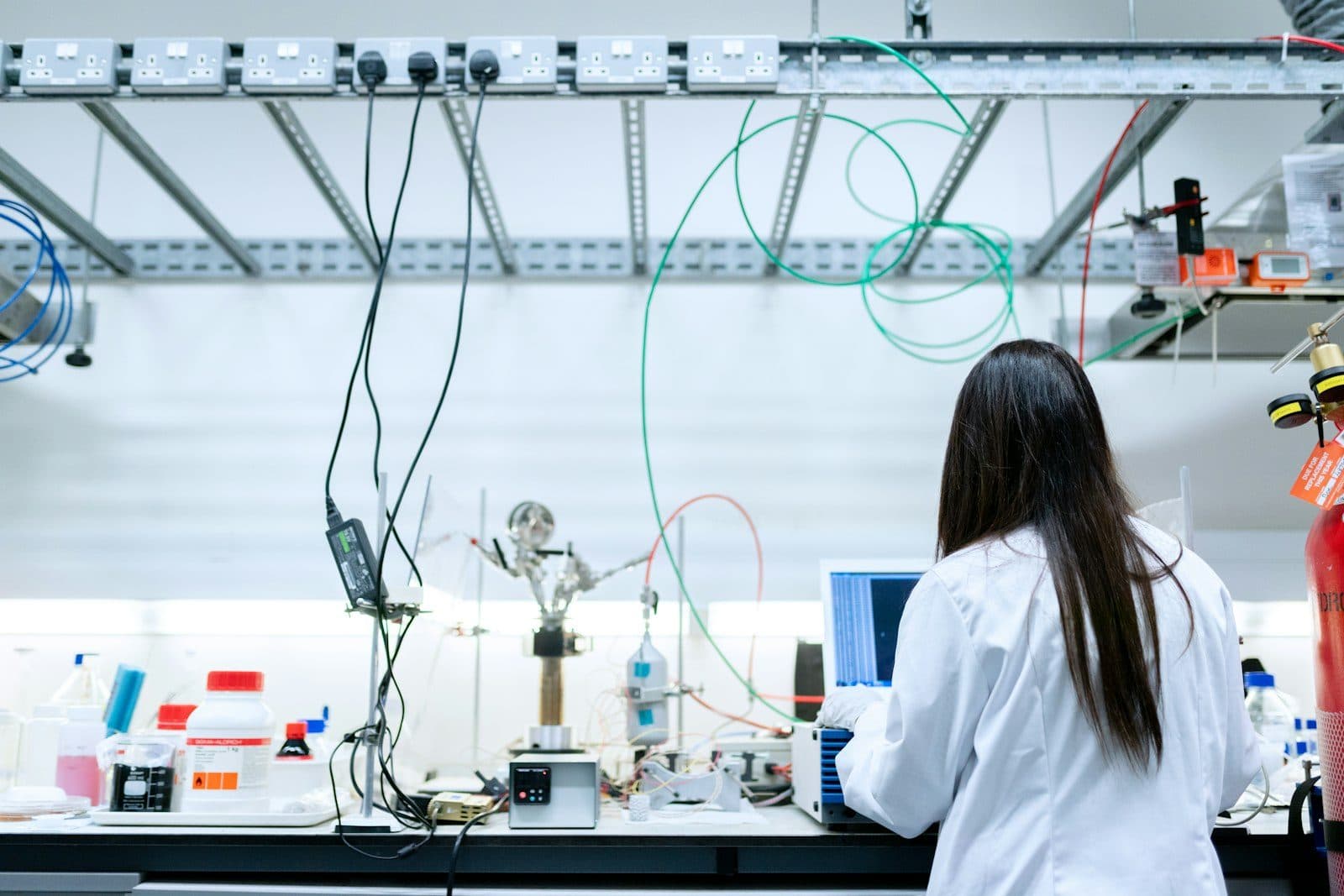 A scientist analysing data on a laptop in the lab